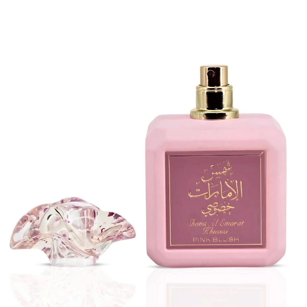 Pink perfume bottle with gold cap on a white background